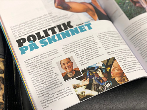 Inside of sexual political magazine Ottar. Text sais Politik on the skin and foto of a smiling tattooer Soledad and Sara tattooing with a Dyke hard T-shirt.
