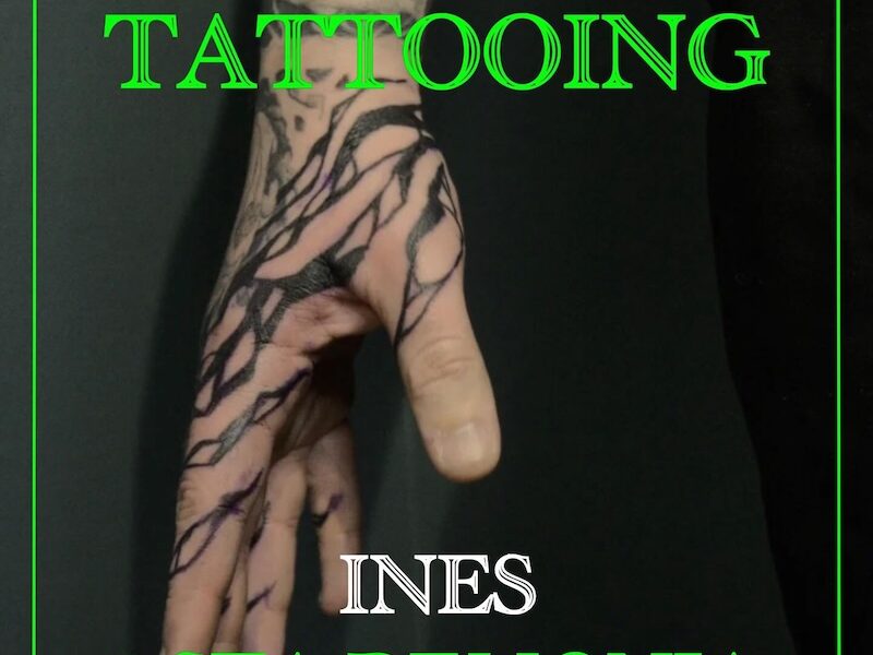 Liquid shapes in black over hand, tattoo in blackwork style by tattooer Ines